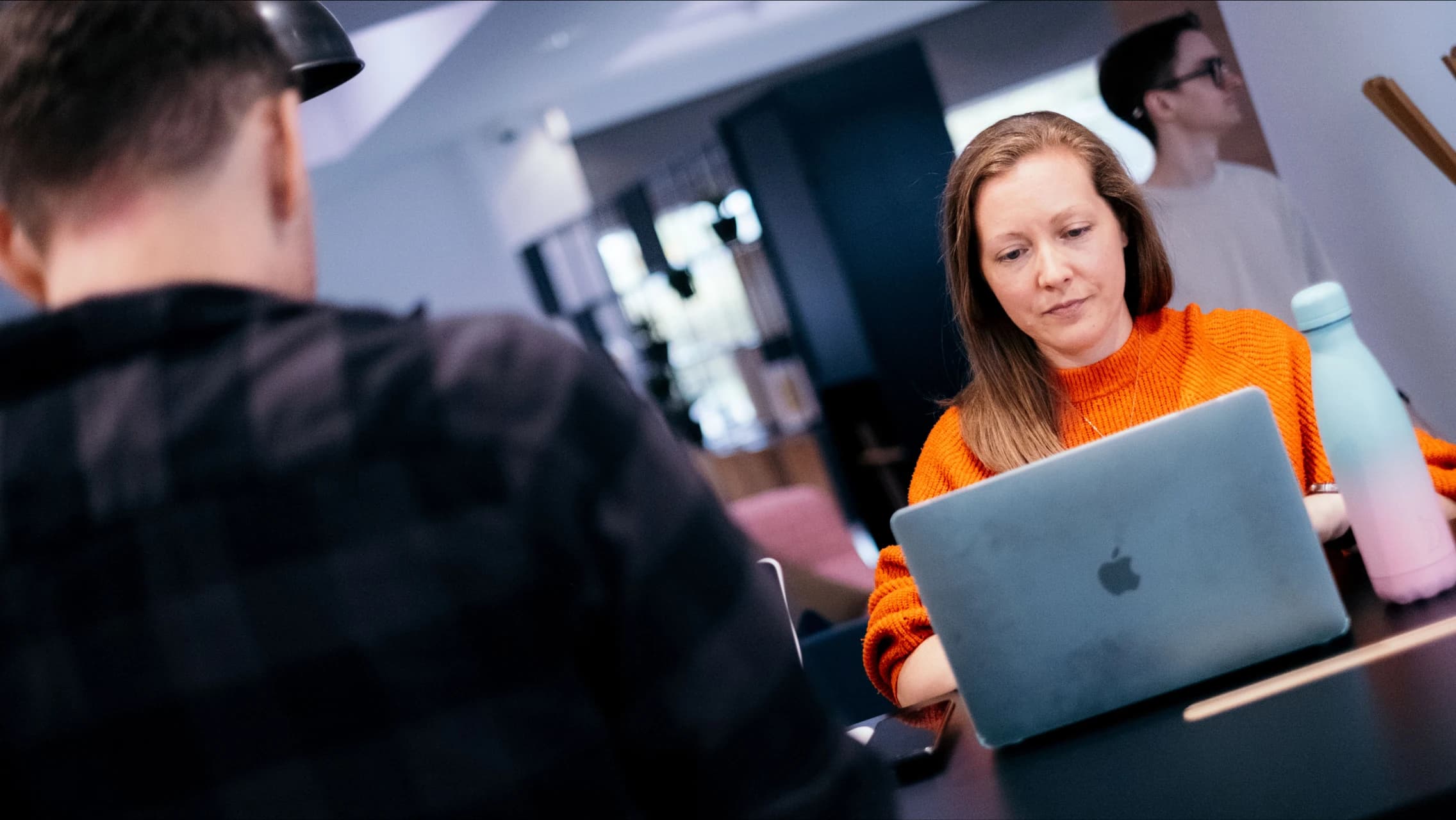 Team members working on laptops